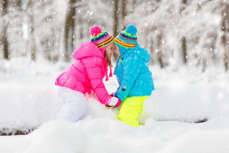 Girls playing in the snow demonstrating that outdoor play is valuable in every season