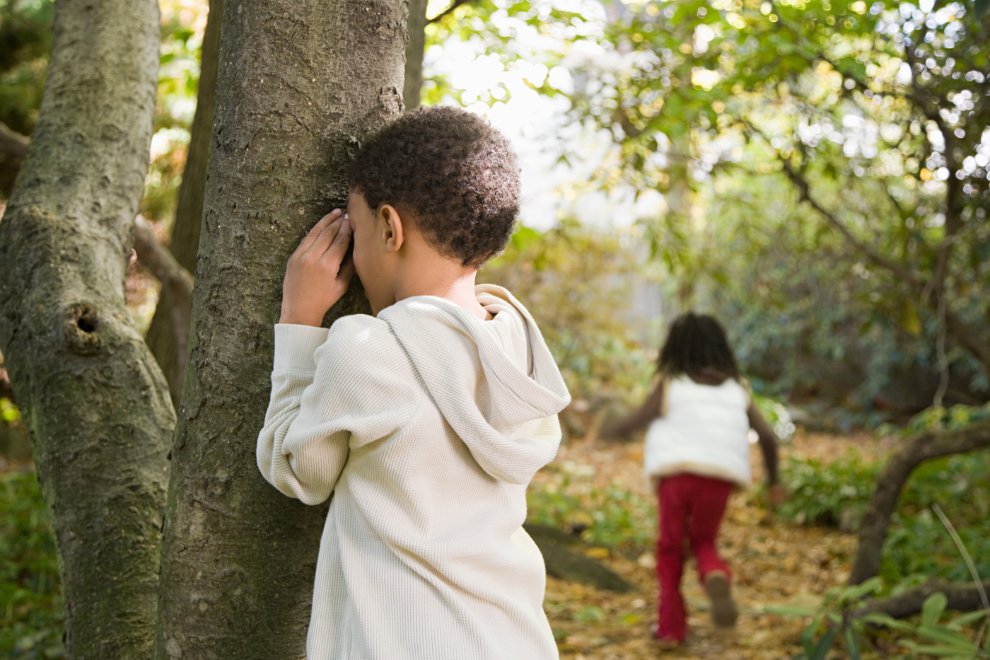Children playing hide and seek outdoors showing the social benefits of active play
